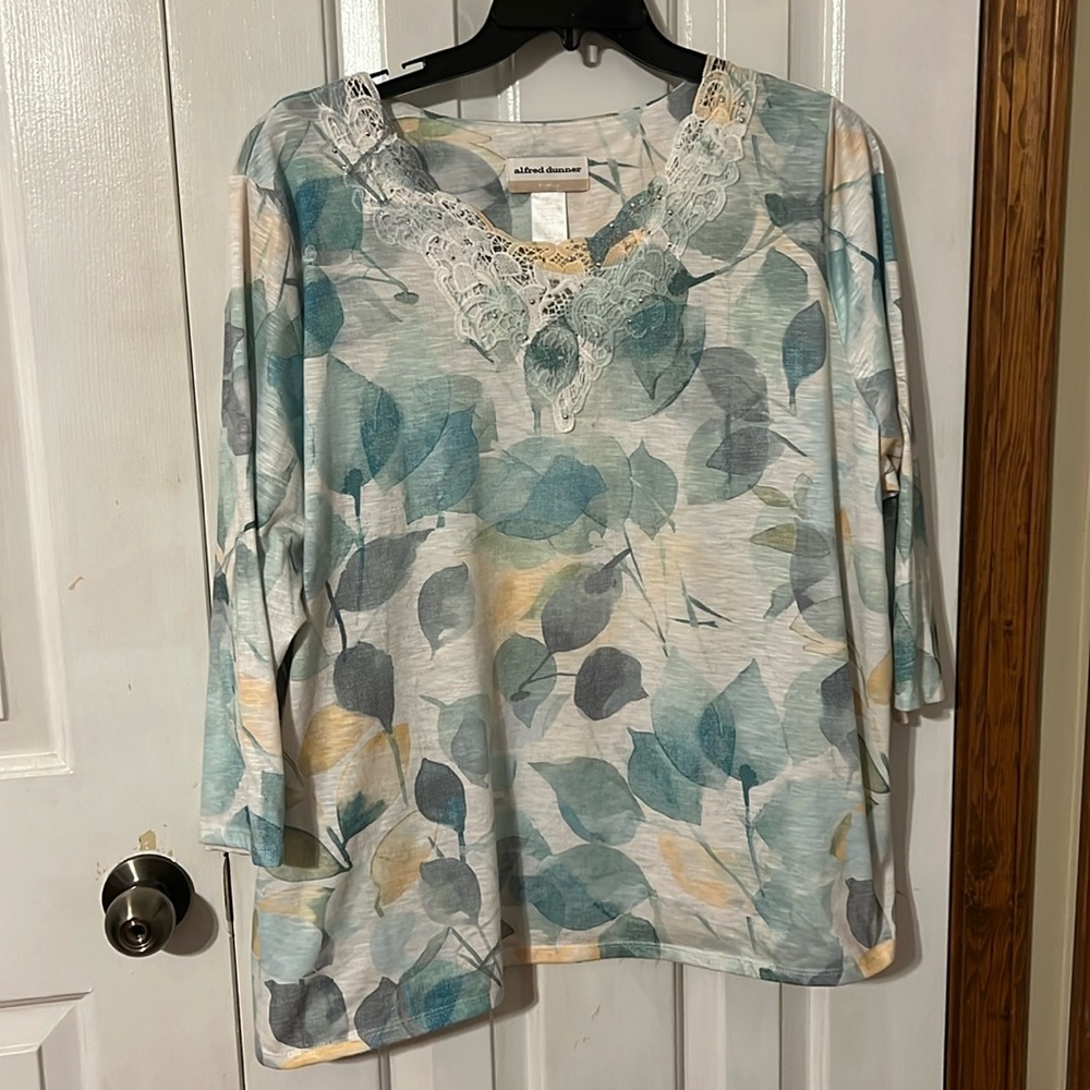 Plus womens textured lace neck summer top. 3/4 sleeves, split side hems.